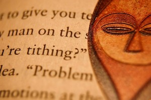 book with "tithing" highlighted and African bookmark