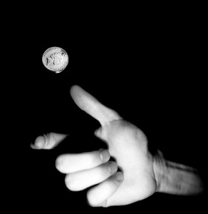 hand flipping a coin